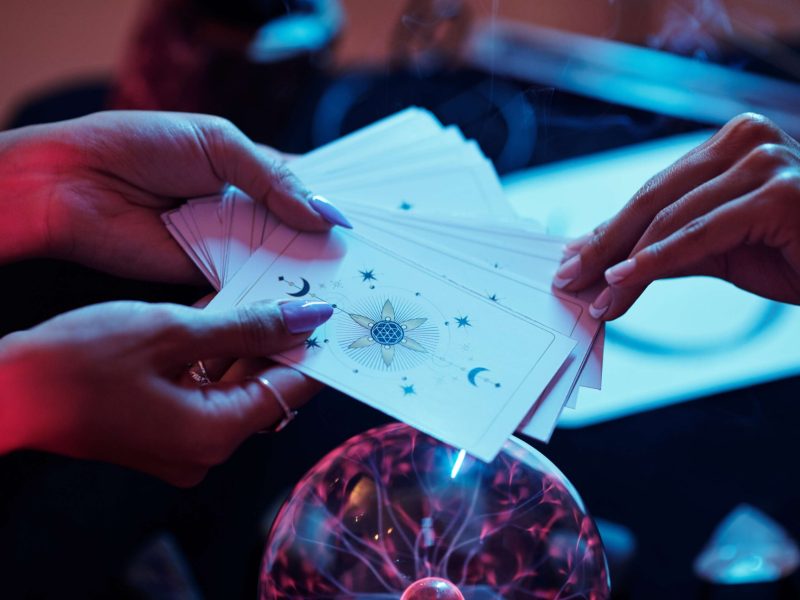 hands-holding-tarot-cards-over-a-plasma-ball-2026-09-23-08-36-56-utc